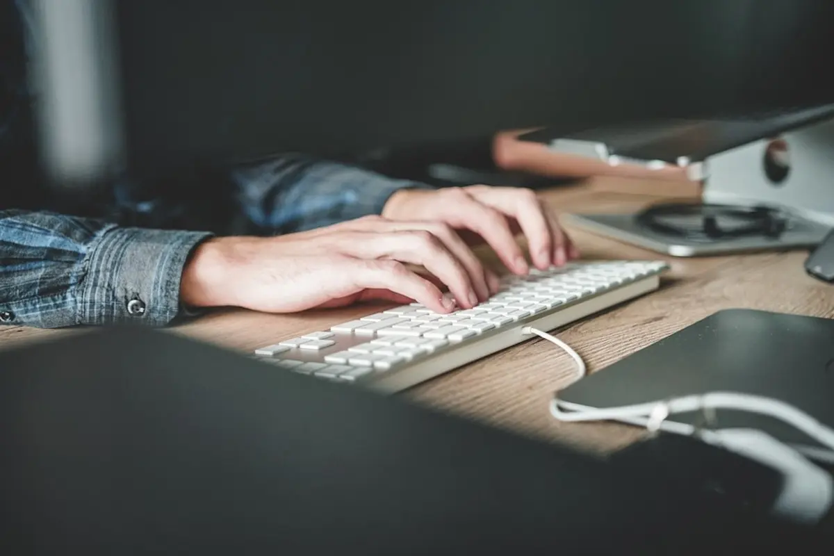 people sitting on chair in front of computer monitor