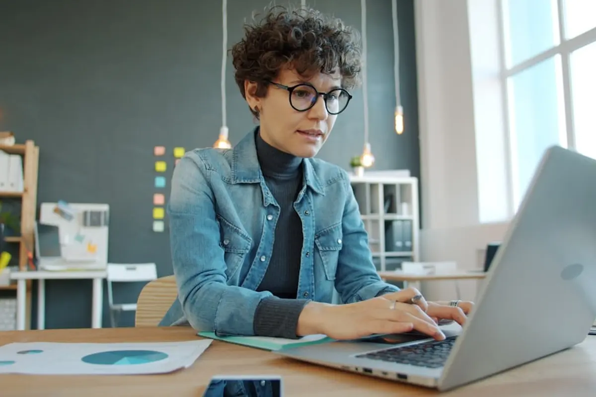 people sitting on chair in front of computer monitor