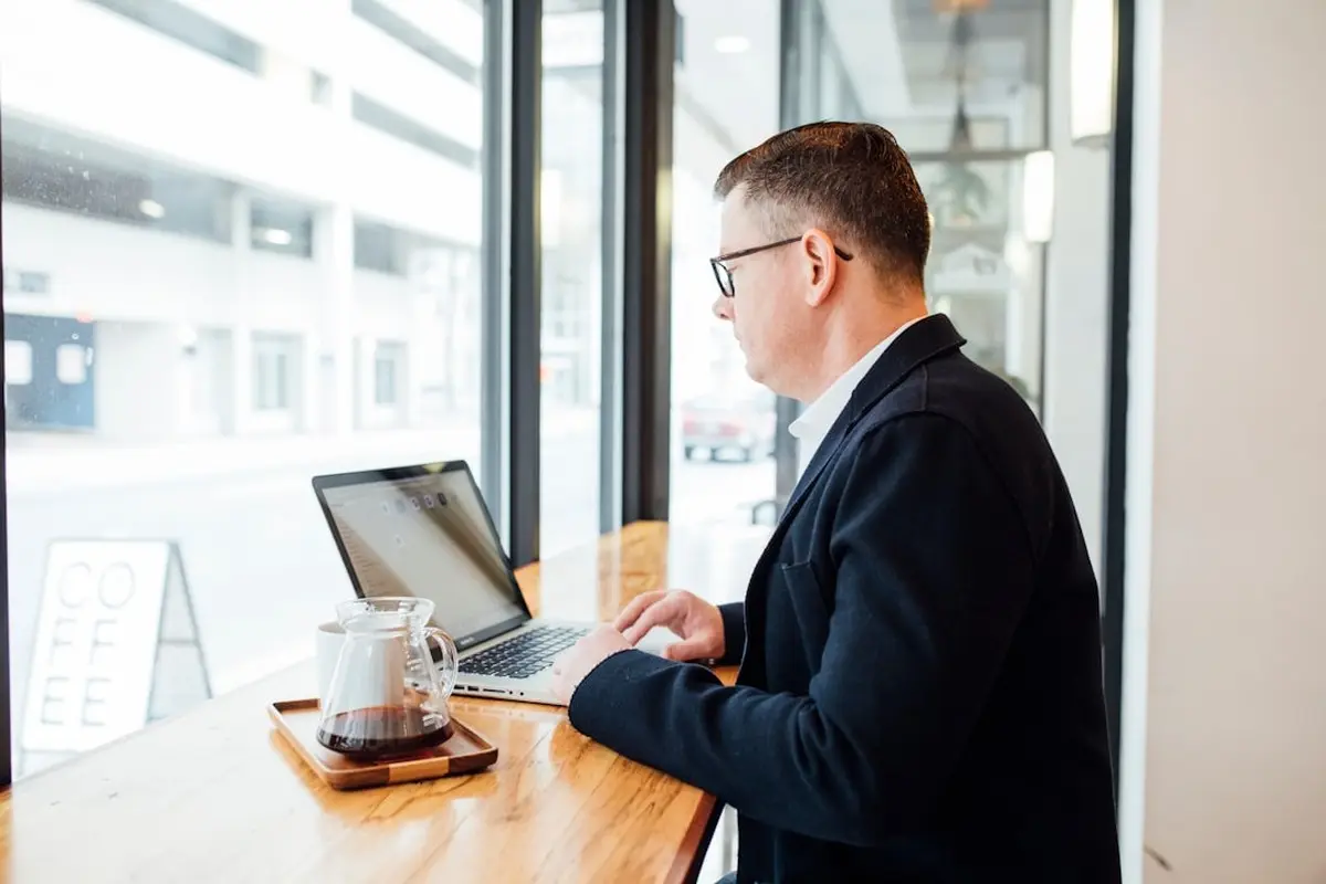 people sitting on chair in front of computer monitor