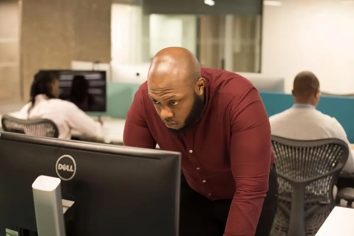 people sitting on chair in front of computer monitor