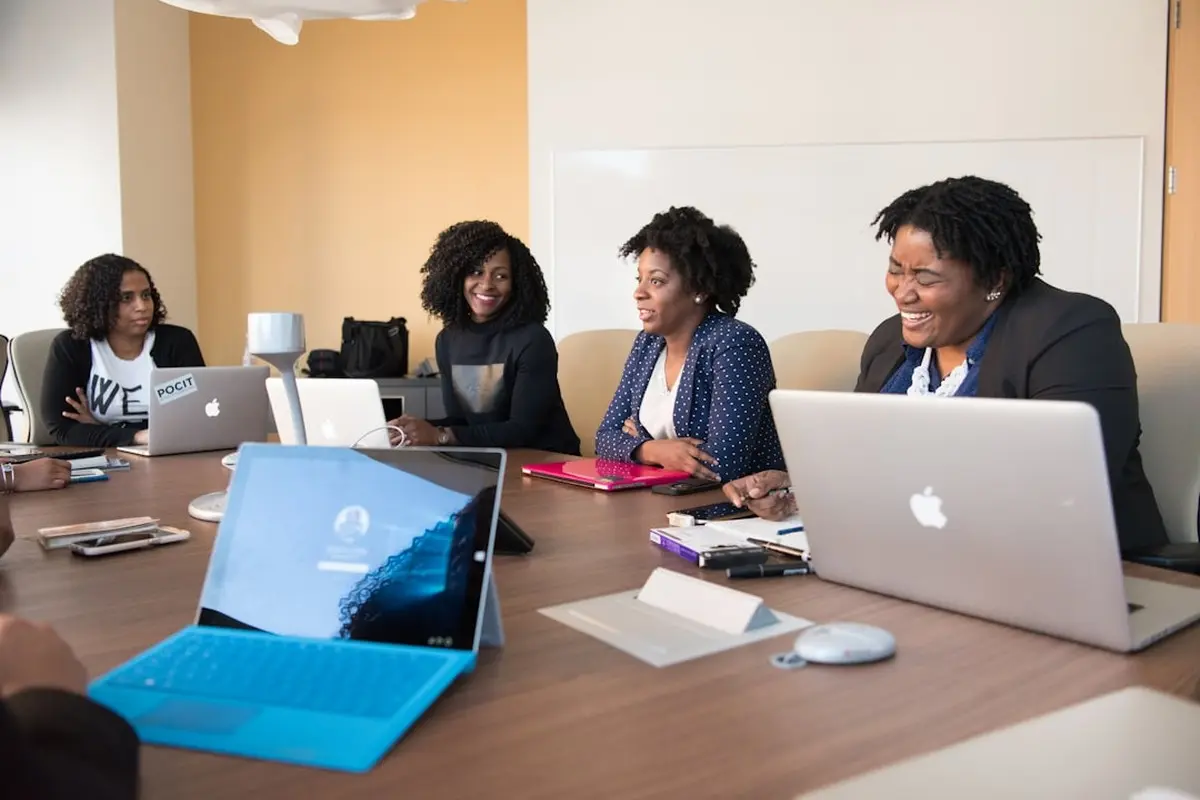 people sitting on chair in front of computer monitor